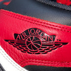 Red leather sneaker panel with Air Jordan wing logo and black lace guard trim.