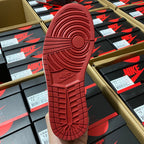 Red sneaker outsole with traction tread and circular pattern details.