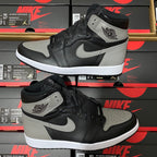 Pair of black and light gray high-top sneakers with white swoosh and padded ankle collar