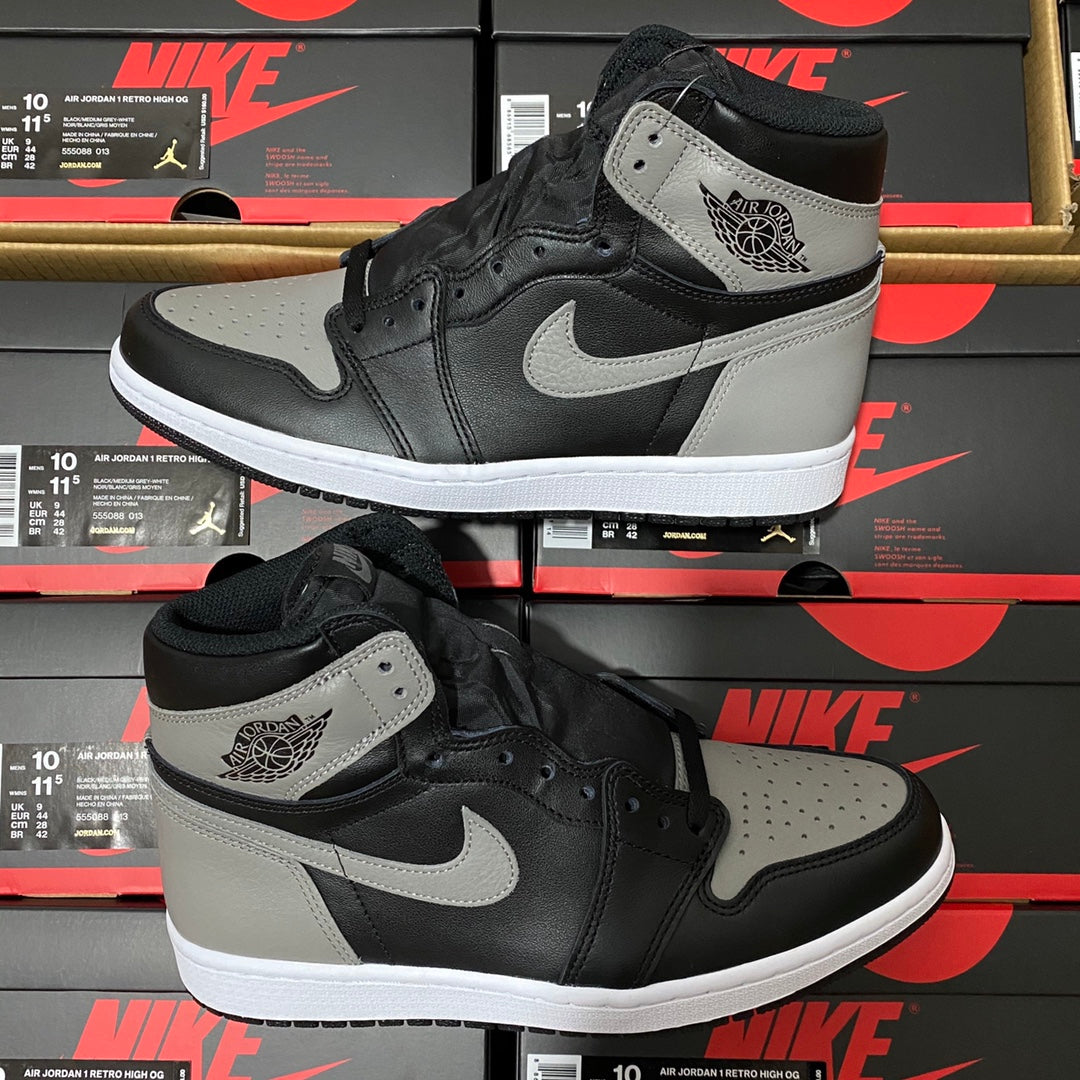 Pair of black and light gray high-top sneakers with white swoosh and padded ankle collar