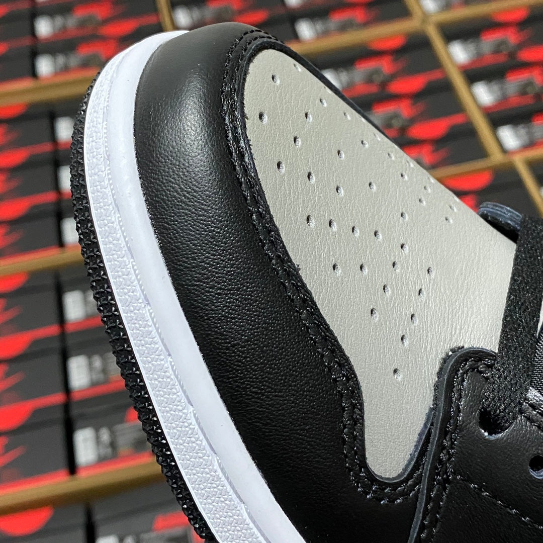 High-top sneaker side panel with textured black leather, light gray overlays, and perforations