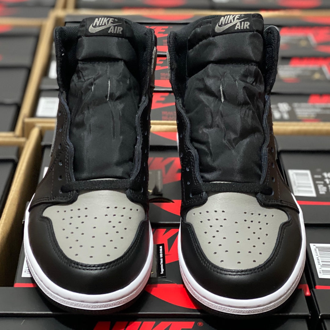 Back view of black high-top sneakers with light gray toe panels and white rubber outsole