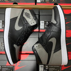 Black and light gray high-top sneakers with white midsole, swoosh logo, and lace-up uppers