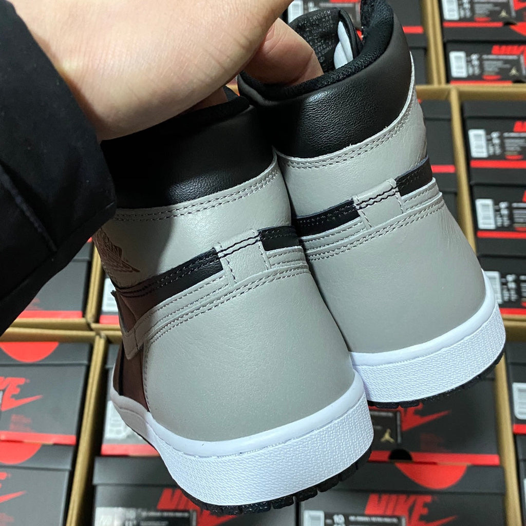 High-top sneaker heel and back panel in black and light gray with white midsole
