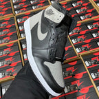 High-top sneaker in black and dark gray with white leather panels and lace-up closure