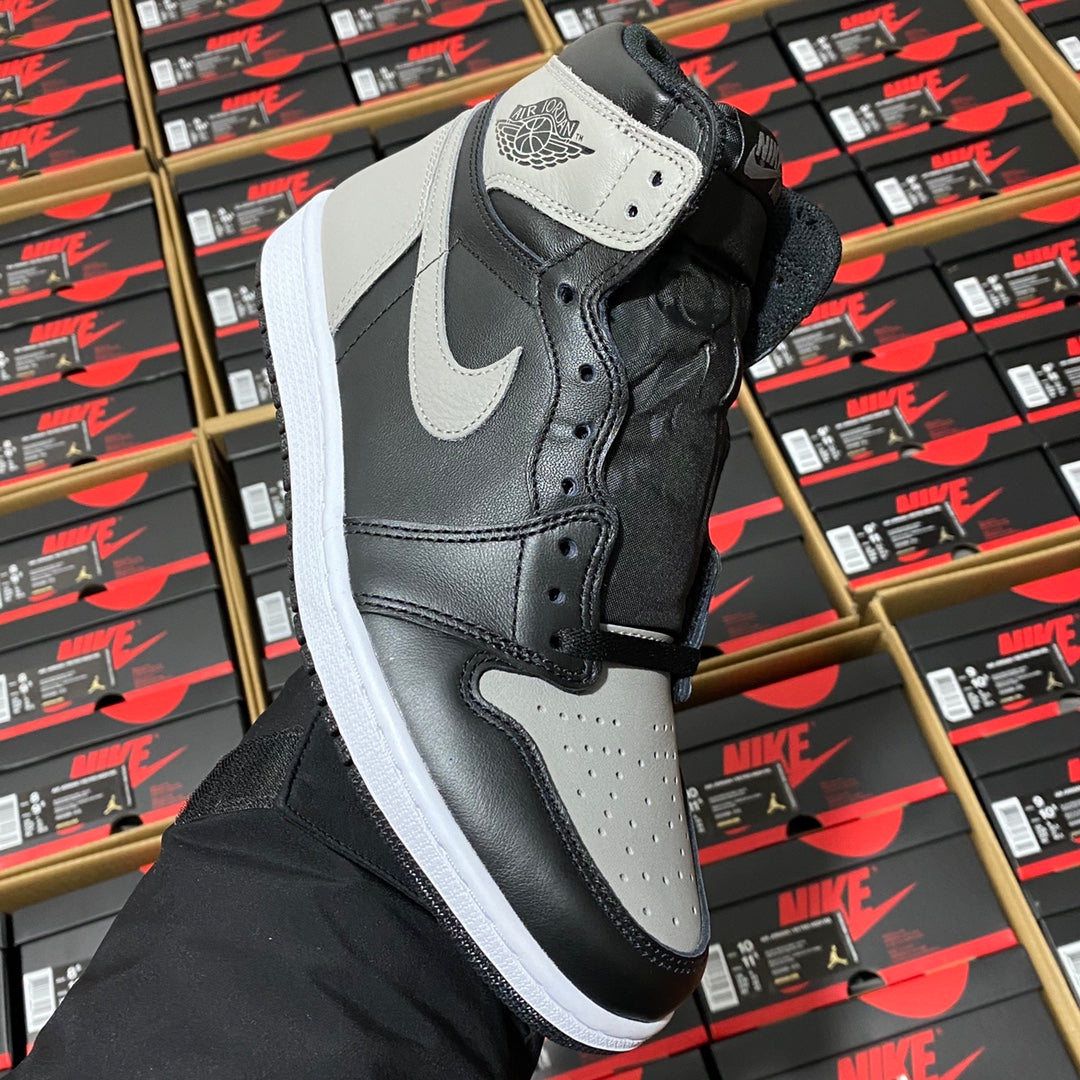 High-top sneaker in black and dark gray with white leather panels and lace-up closure