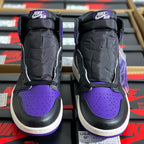 Back view of high-top sneakers with black padded collars, purple toe panels, and Nike Air tabs