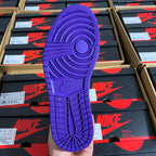 High-top sneaker outsole in bright purple with tread pattern and circular traction logo