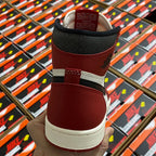 High-top sneaker heel in burgundy with black collar and cream outsole.