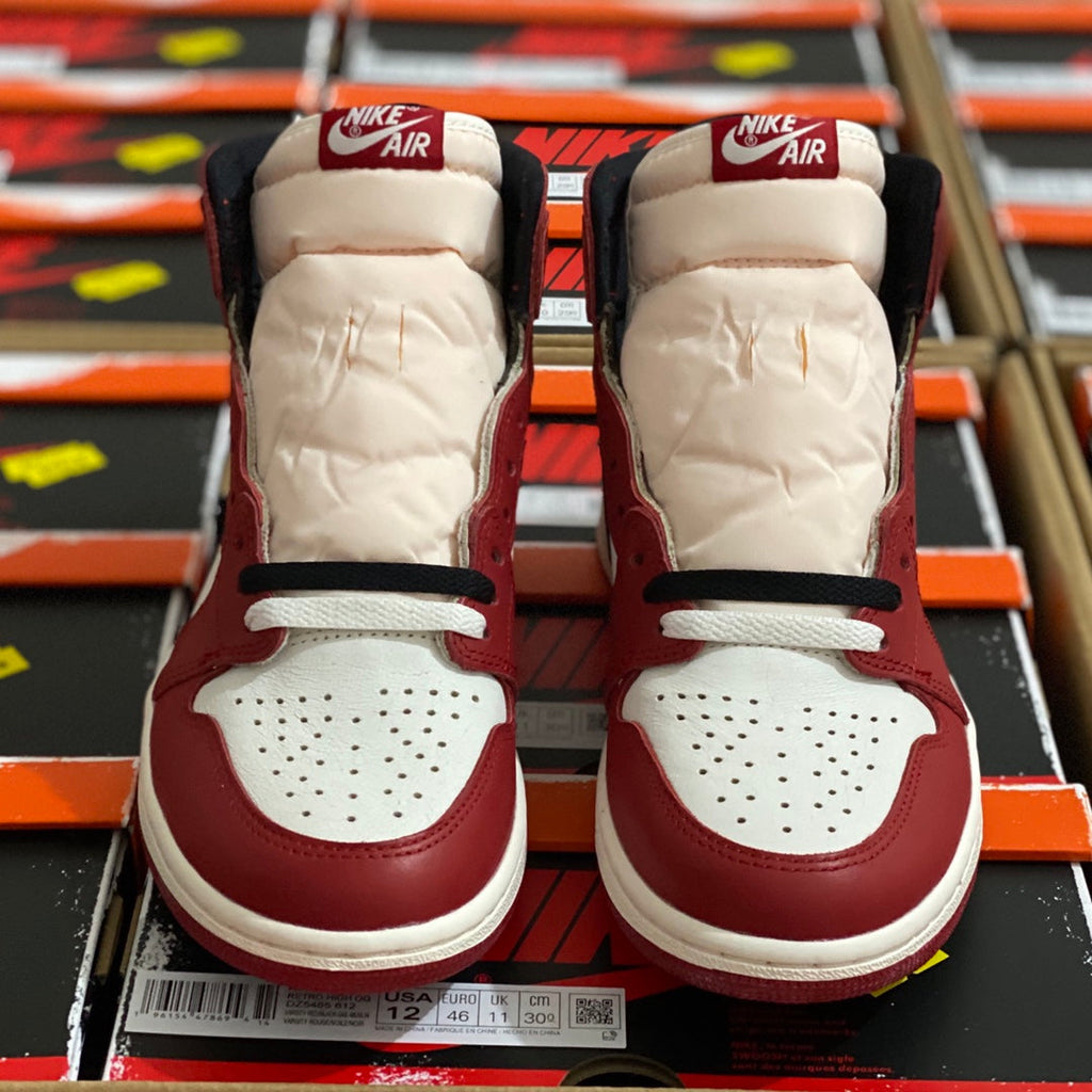 Pair of high-top sneakers in burgundy and white with AIR heel branding.