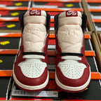 Pair of high-top sneakers in burgundy and white with AIR heel branding.