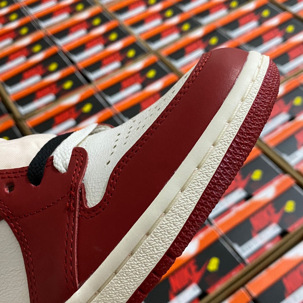 Close-up of high-top sneaker upper with burgundy leather and white side trim.