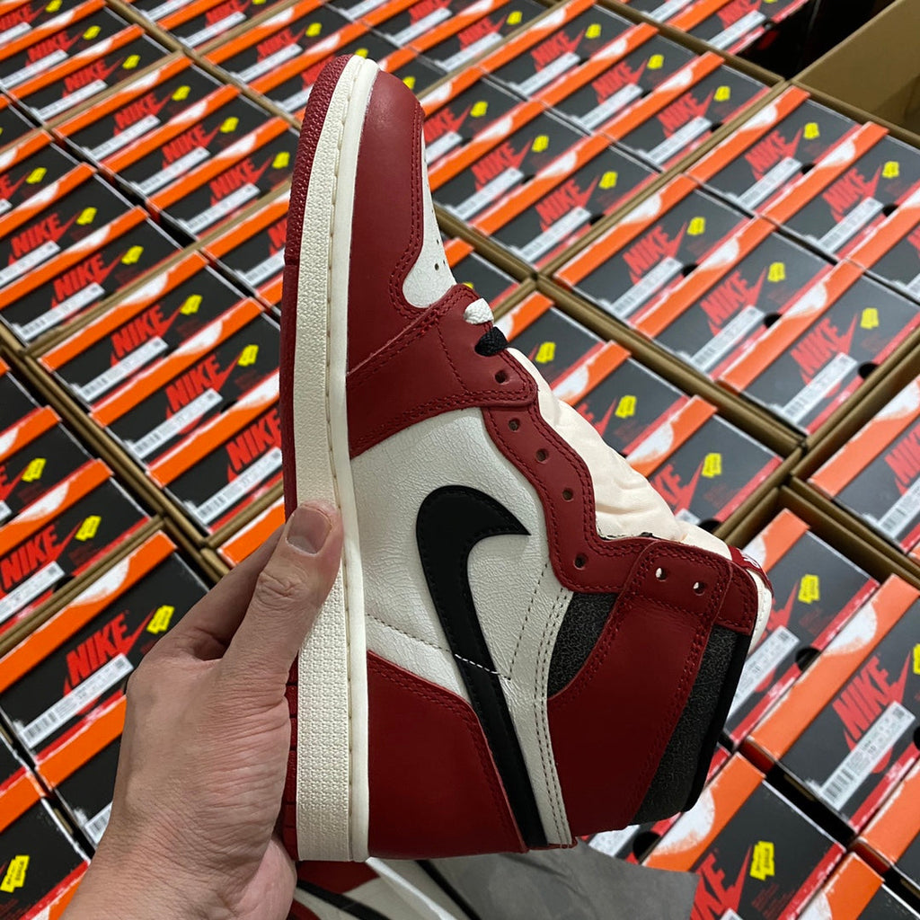 High-top sneaker side view in burgundy and white with black swoosh and laces.
