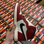 High-top sneaker side view in burgundy and white with black swoosh and laces.