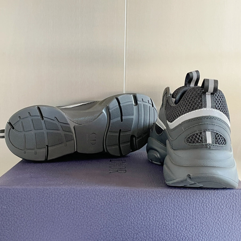 Gray sneakers with dark outsole treads, shown from side and heel perspective.