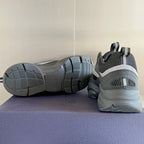 Gray sneakers with dark outsole treads, shown from side and heel perspective.