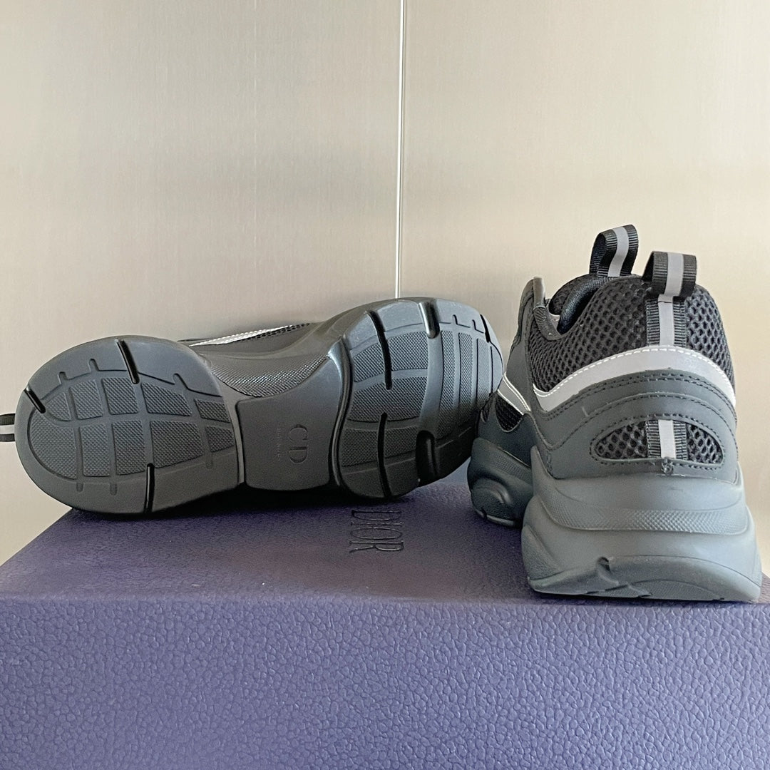 Gray sneakers with dark outsole treads, shown from side and heel perspective.