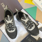Gray and black mesh sneakers with white heel accents and lace-up closure.