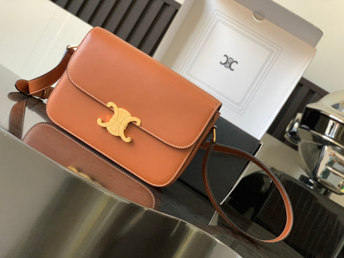 Celine bag in orange leather with gold logo on front flap and shoulder strap