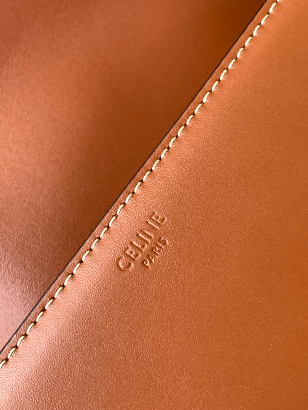 Celine bag leather edge with visible topstitching and small embossed brand text