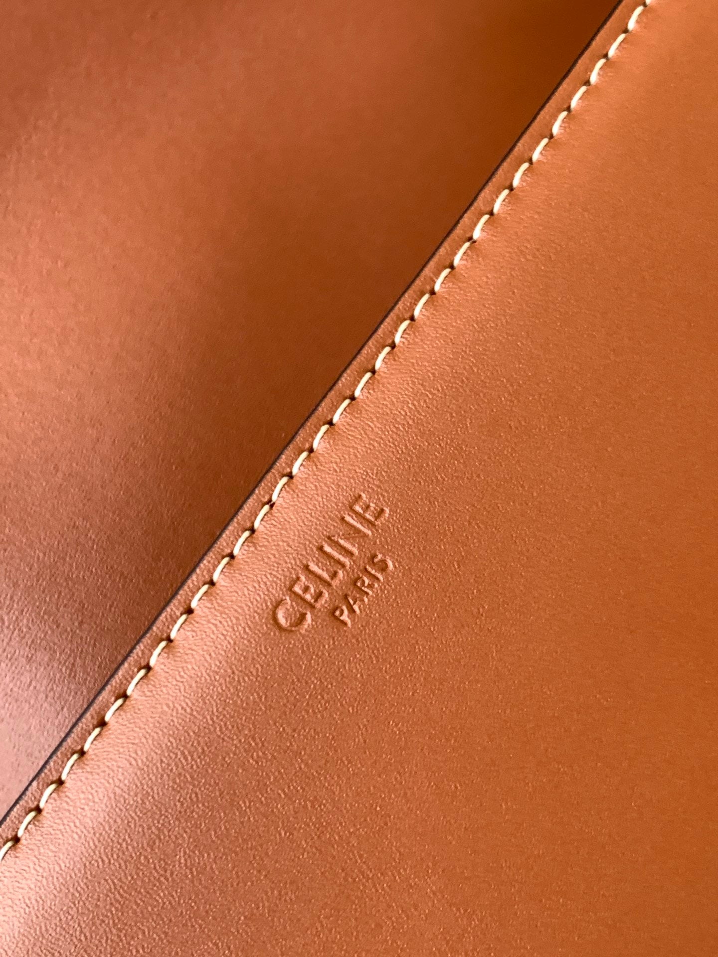 Celine bag leather edge with visible topstitching and small embossed brand text