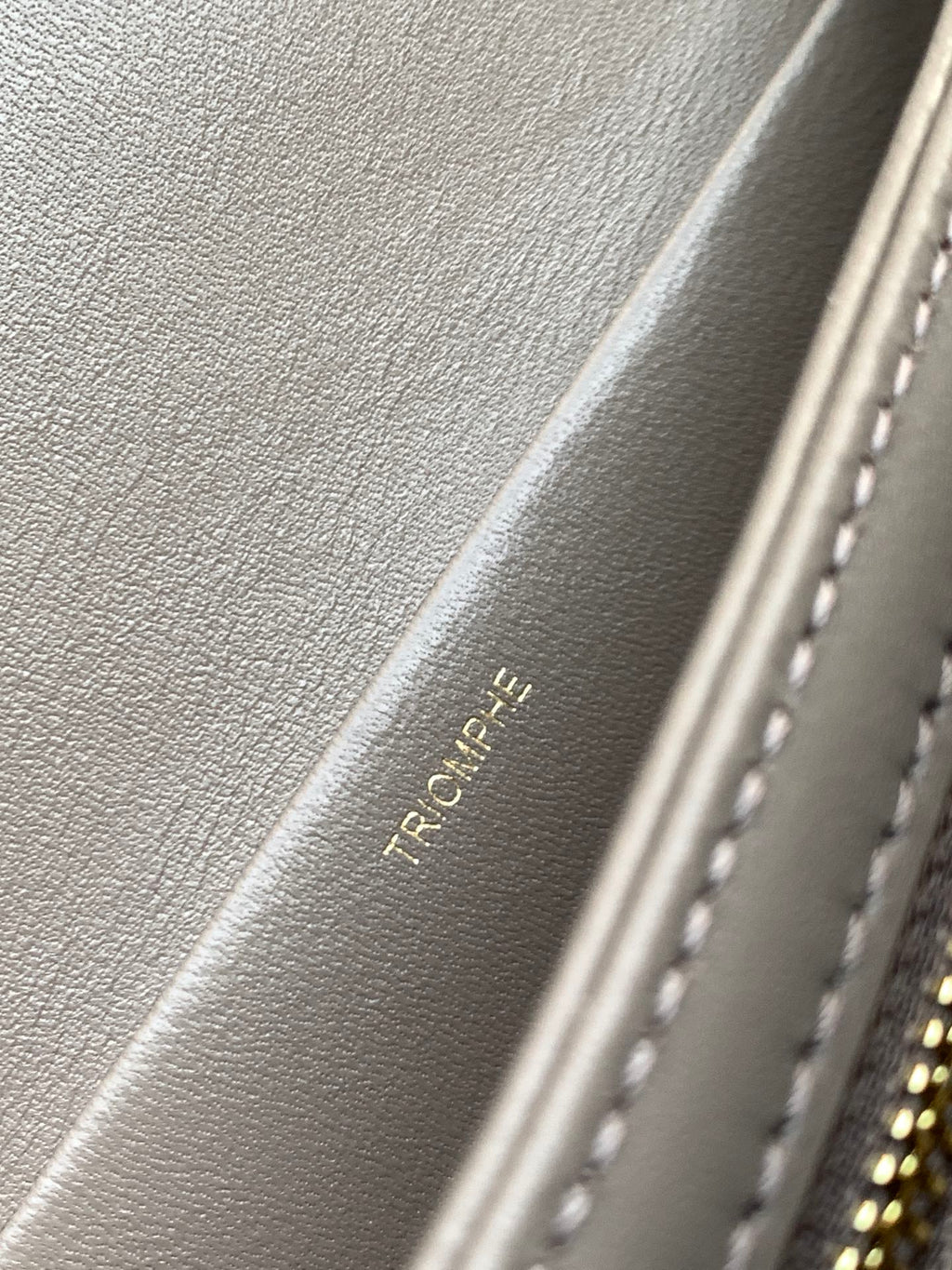 Beige Celine leather interior with embossed text and stitched edge