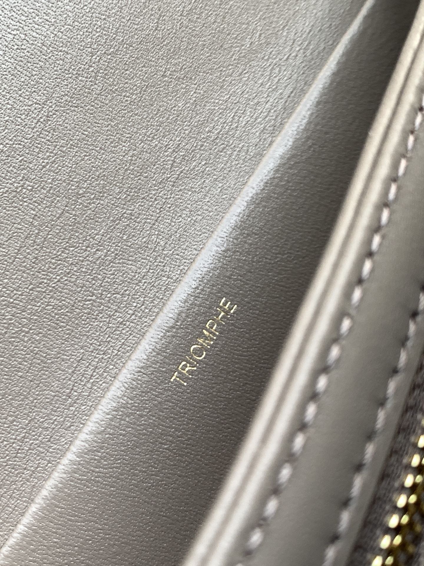 Beige Celine leather interior with embossed text and stitched edge