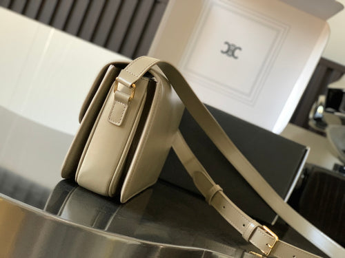Beige Celine crossbody bag, side view with adjustable leather strap and gold buckle