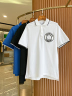 White polo shirt with black-trim collar and Burberry England logo patch on chest
