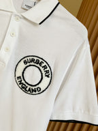 White polo shirt with button placket and Burberry England circular logo embroidery