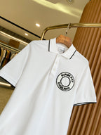 White polo shirt on hanger, black-trim collar with Burberry England logo at chest