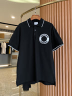Black short-sleeve polo shirt with button placket, white-trimmed collar, circular chest logo