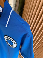 Blue polo shirt sleeve with Burberry England logo patch detail