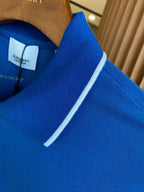 Blue polo shirt collar with white trim along the neckline