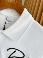 White Burberry polo shirt collar and buttons with size tag and embroidered logo