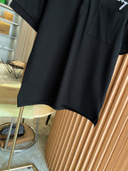 Black short-sleeve polo shirt hem with smooth fabric and side seam detail