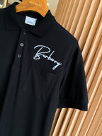 Burberry short-sleeve polo shirt in black with white script logo on chest
