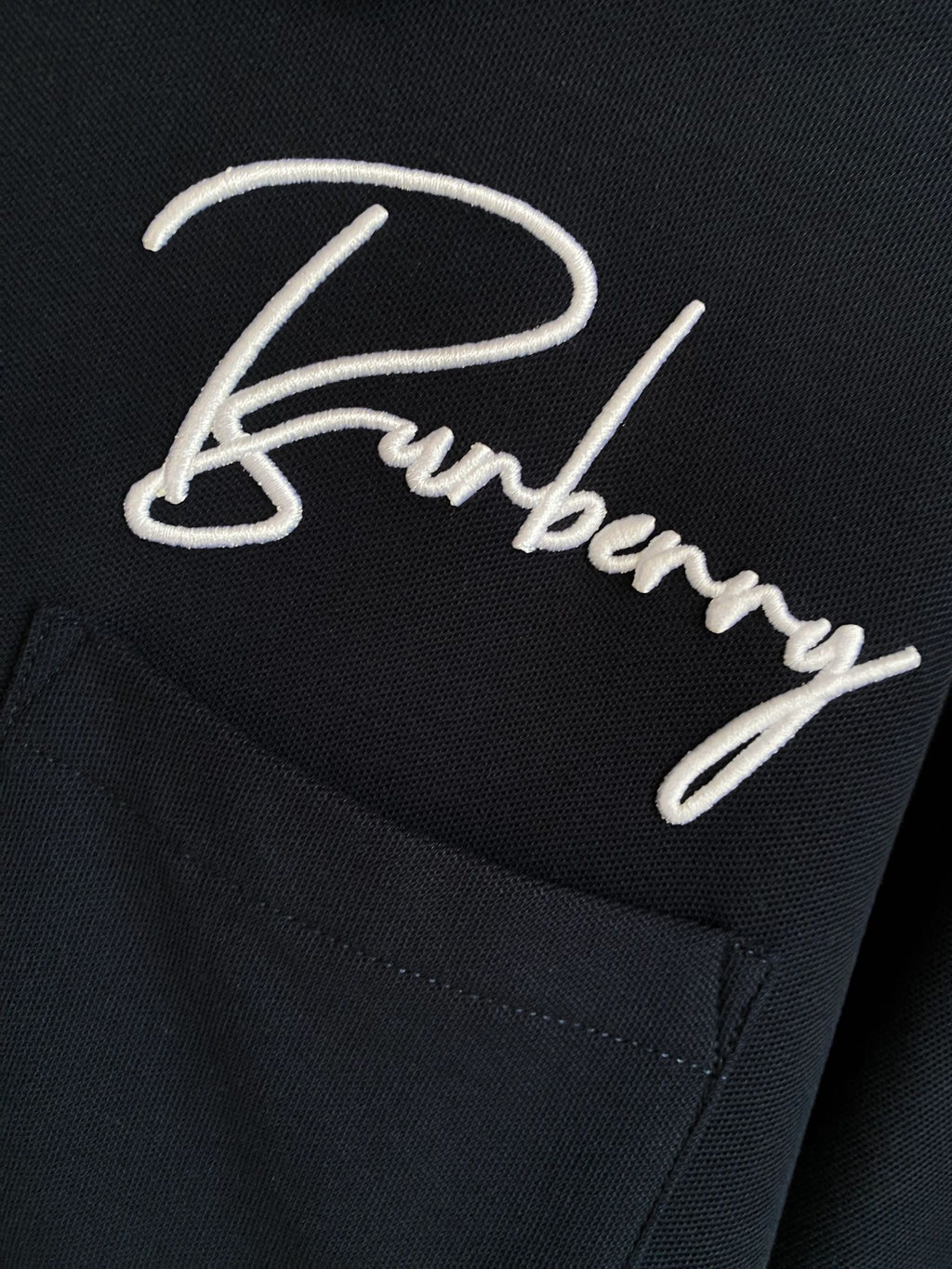Burberry polo shirt dark navy close-up of embroidered logo script and chest pocket