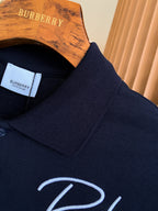 Burberry polo shirt collar detail in dark navy with ribbed trim, partial logo embroidery