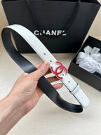 Leather belt with Chanel logo buckle, light cream strap looped over hand