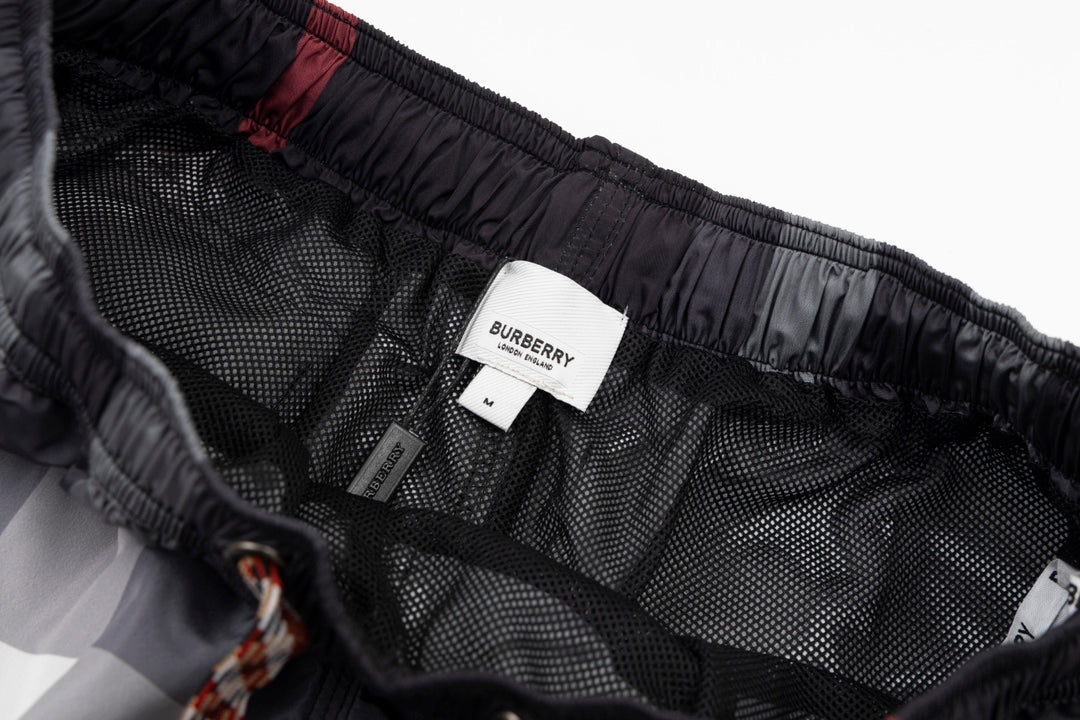 Plaid pants interior showing Burberry label and mesh lining on elastic waist