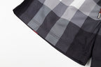 Plaid pants with curved hem and visible stitching, dark gray and light gray check