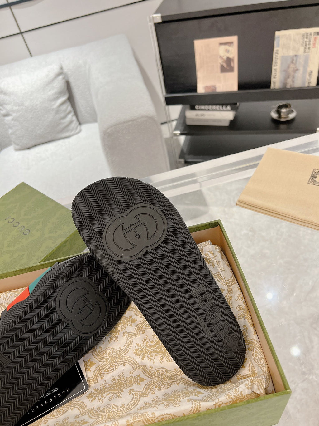 Black Gucci slide sandals showing textured outsole with embossed interlocking G logo
