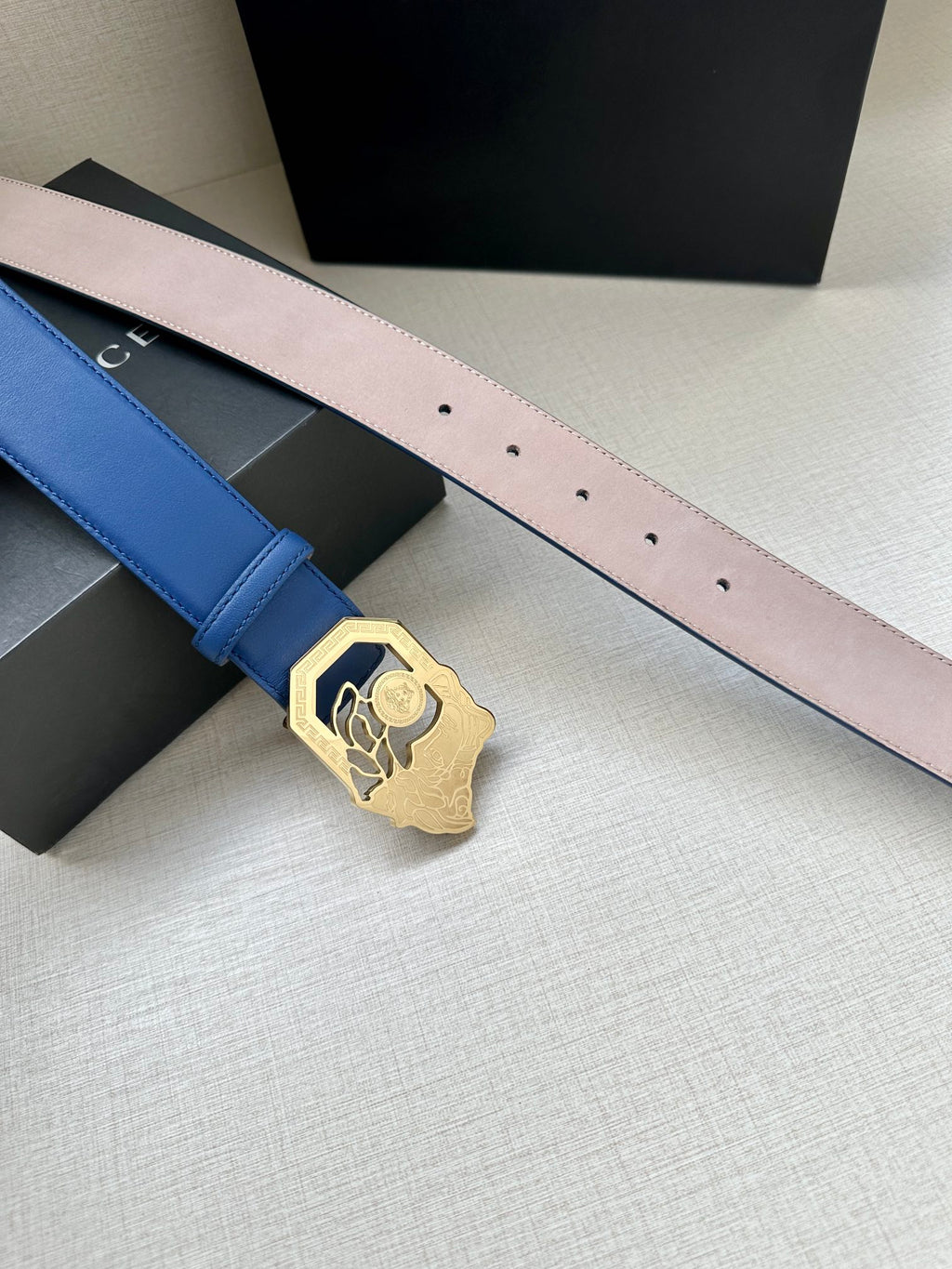 Versace belt on blue strap with gold-toned Medusa buckle and pin holes