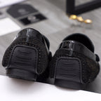 Versace black rubber-soled loafers with tread detail, underside view
