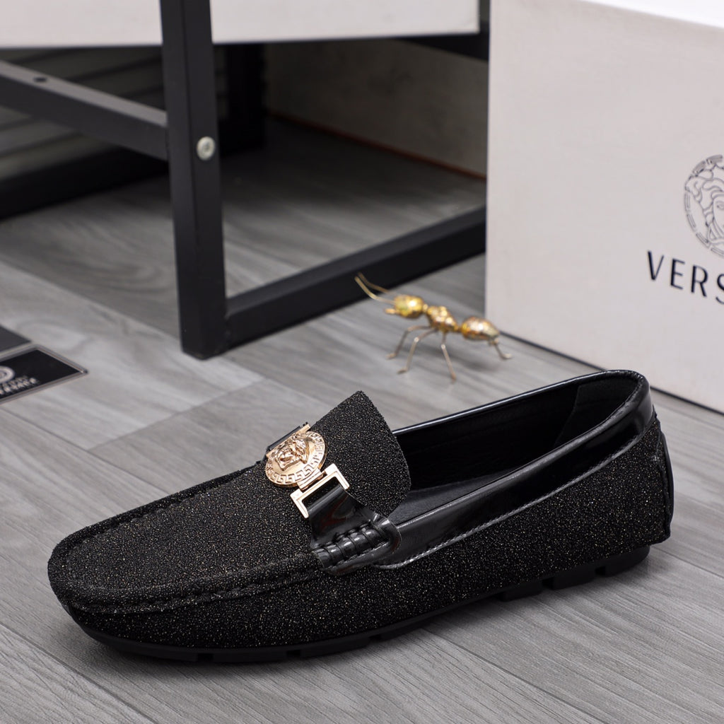Versace black glitter loafers with gold buckle and crest emblem, side angle view