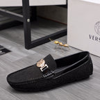 Versace black glitter loafers with gold buckle and crest emblem, side angle view