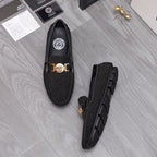 Versace black glitter loafers with gold buckle and crest emblem, front and side