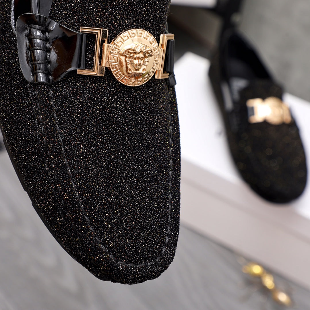 Versace black glitter loafer front with gold buckle and crest emblem close-up
