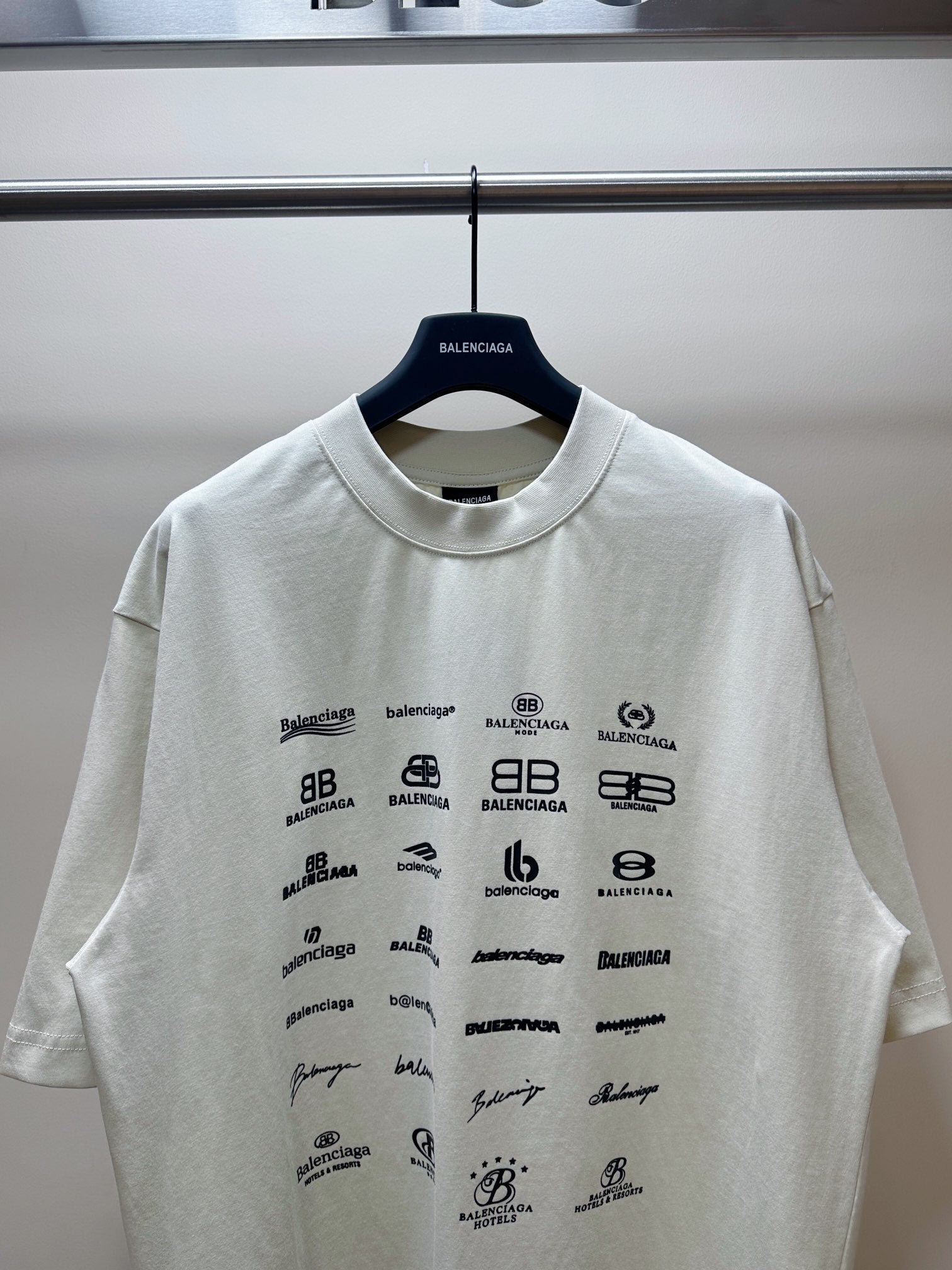 Balenciaga white short-sleeve T-shirt with scattered black Balenciaga logos
